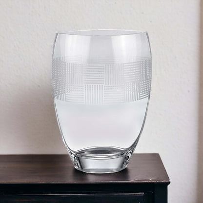 12" clear geometric pattern oval crystal table vase on dark surface.