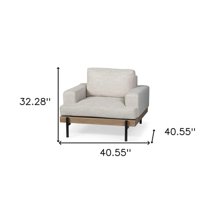 41" cream and black fabric arm chair with solid wood frame, removable cushions, and recessed arms.