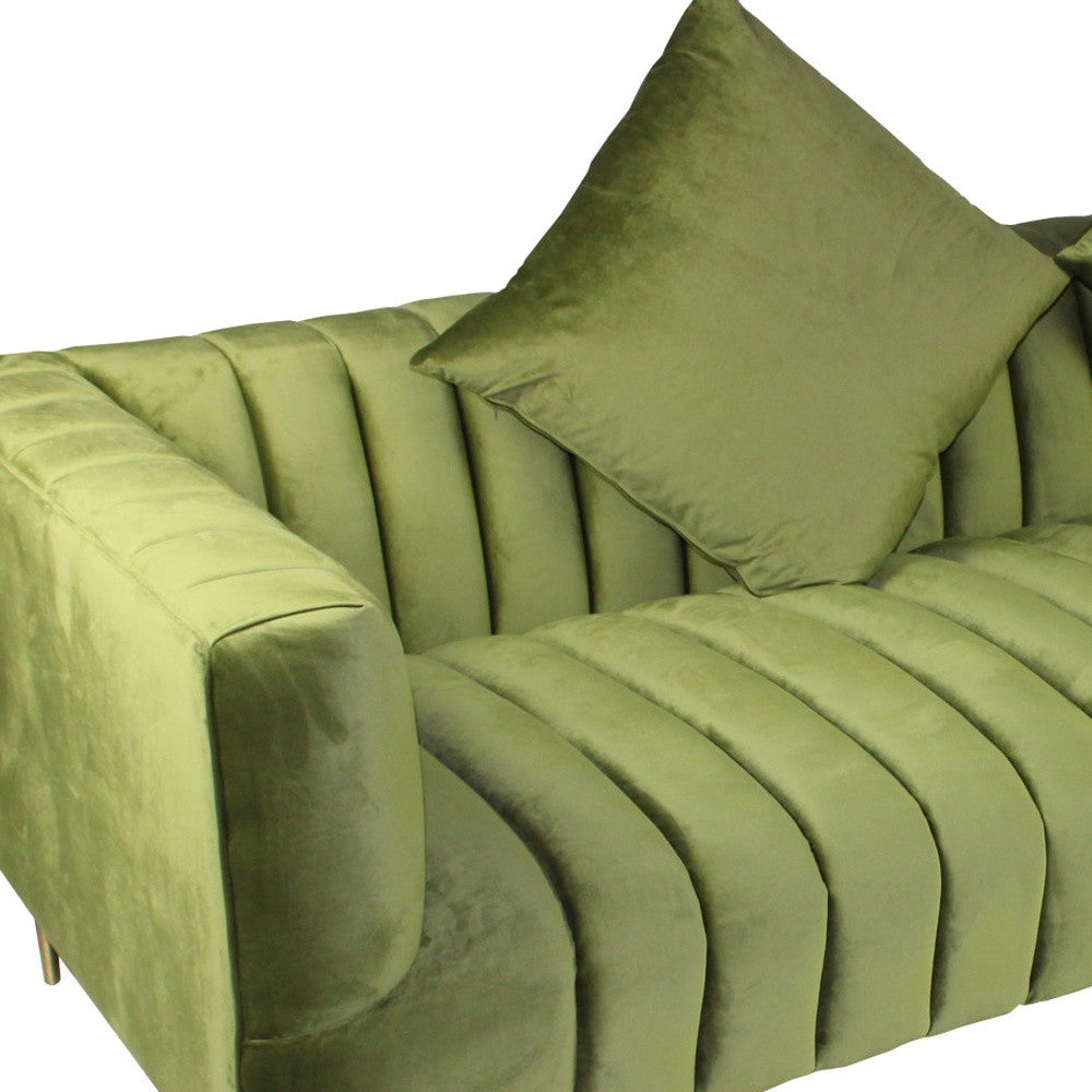 90" olive green velvet sofa with round arms, biscuit back, gold legs, and toss pillows.