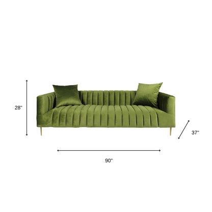 90" olive green velvet sofa with gold legs and toss pillows, featuring a biscuit back and round arms, luxury upholstery, and durable construction.