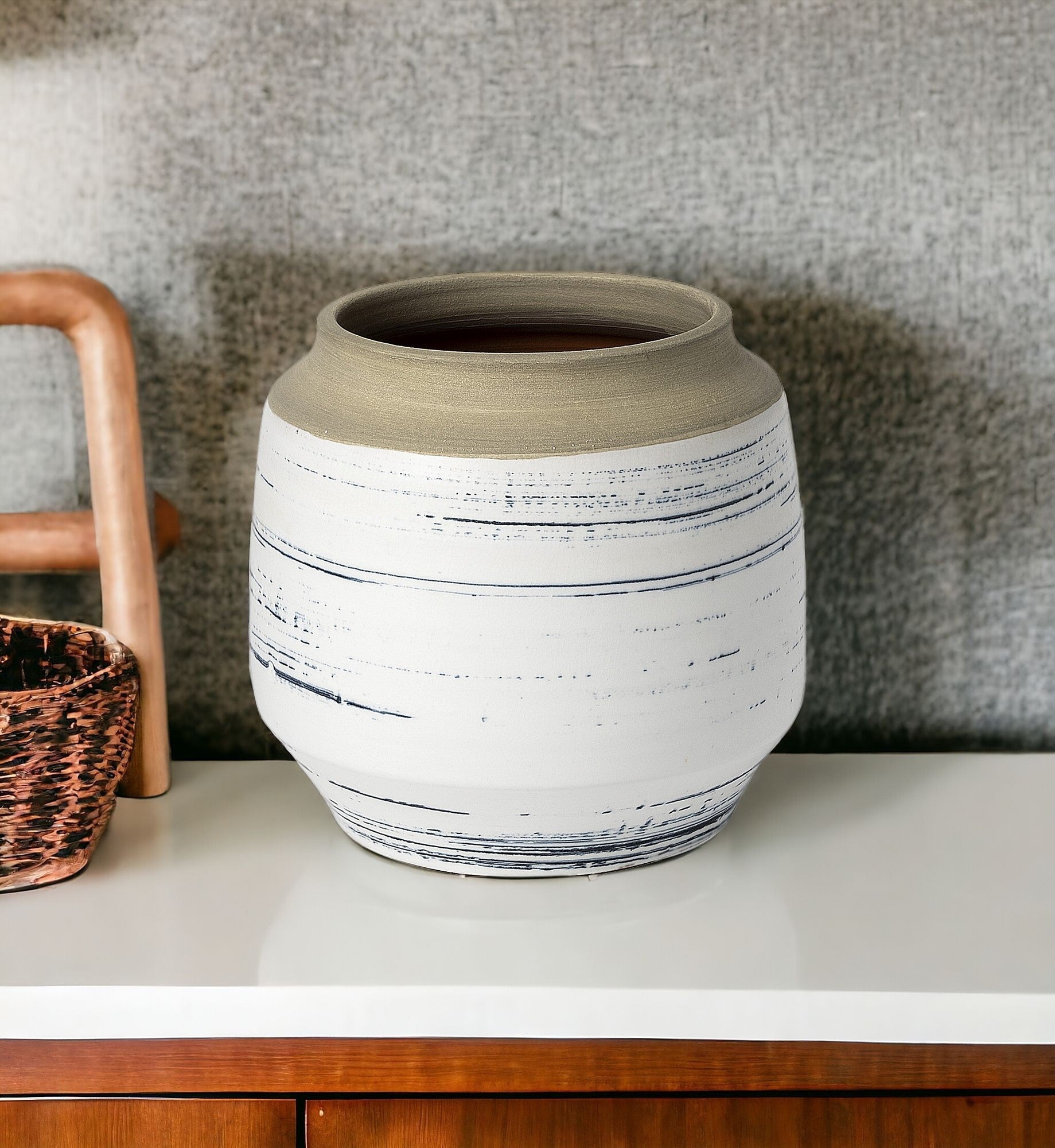 Coastal ceramic vase with blue stripes and light brown top.