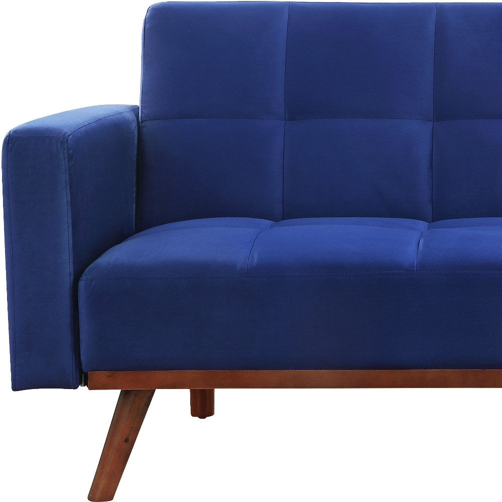 76" blue velvet convertible futon sleeper sofa with brown legs, tufted stitching, and sturdy velvet upholstery.