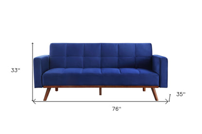 76" blue velvet futon sleeper sofa with brown legs, tufted design, square arms.