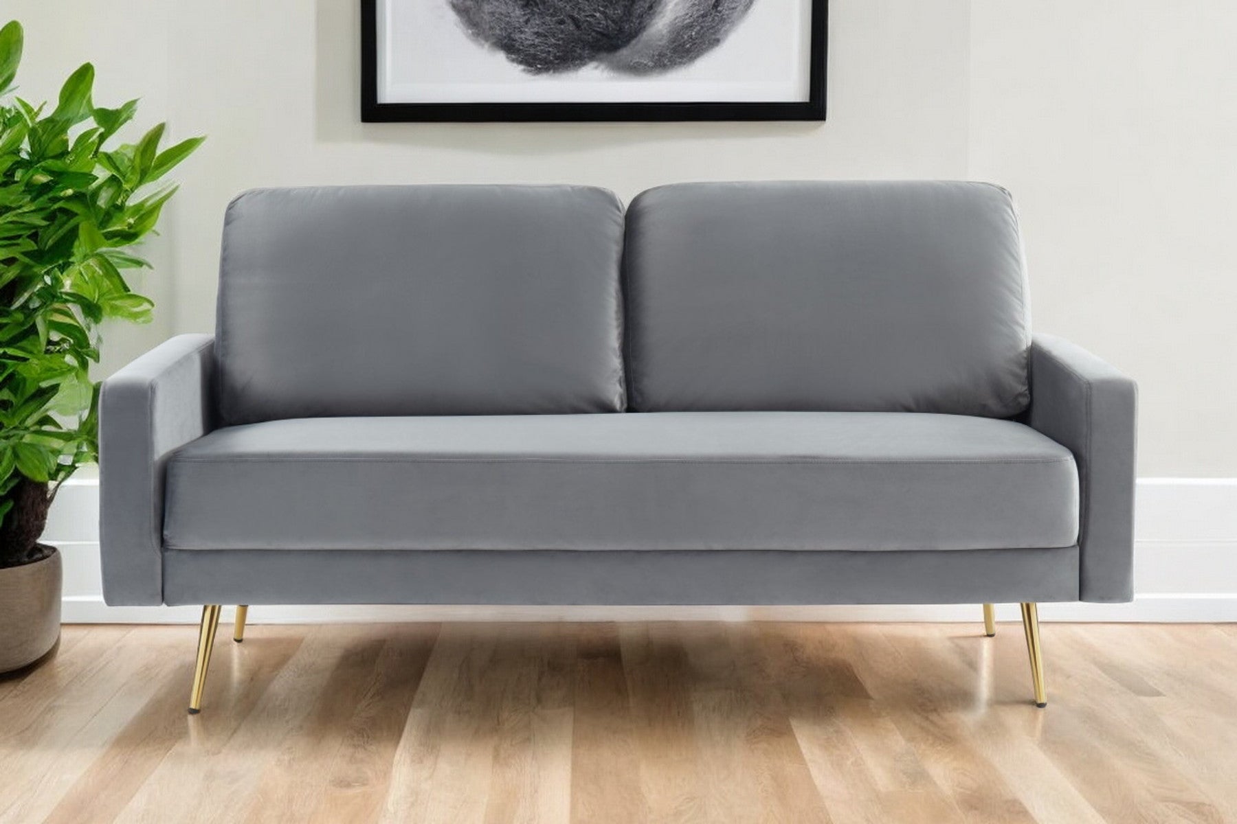 72" gray velvet sofa with brass legs and pillow back design.