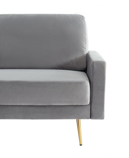 72" gray velvet sofa with brass legs and pillow back design.