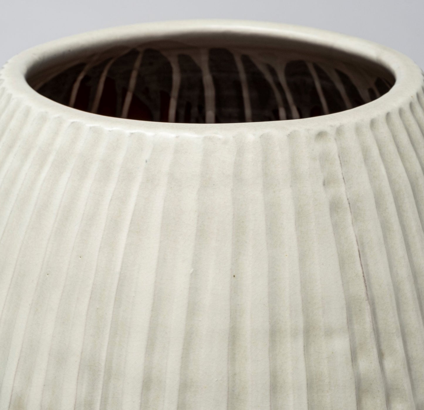 White Embossed Stripes Ceramic Vase with matte finish and textured pattern.