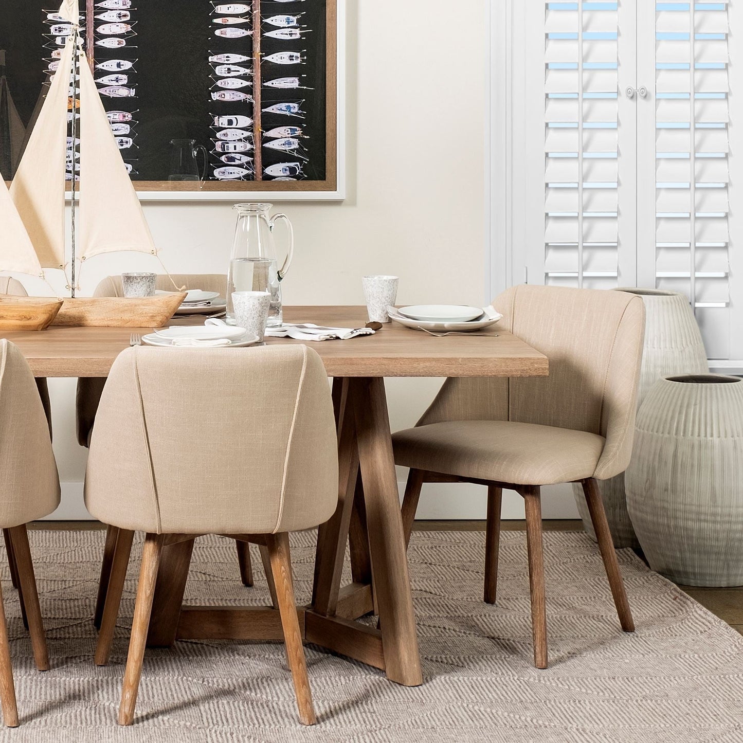 White embossed stripes ceramic vase with matte finish in a dining room setting.