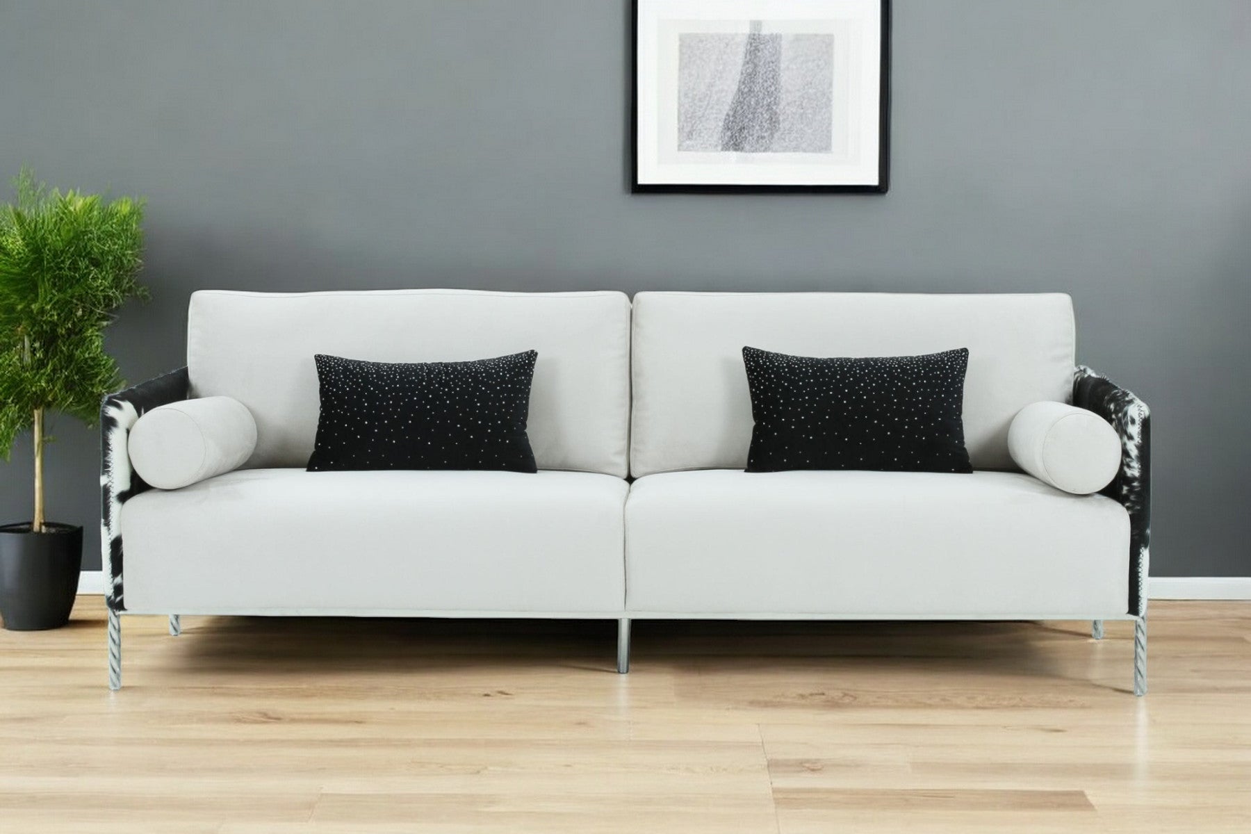 89" white sofa with toss pillows and silver legs in modern living space.