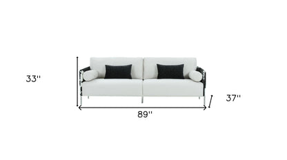 89" white sofa with toss pillows and silver legs, featuring track arms and durable polyester fabric.